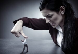 A small man in a suit struggles to push against a giant hand pressing down on him, symbolizing overwhelming pressure and power dynamics.